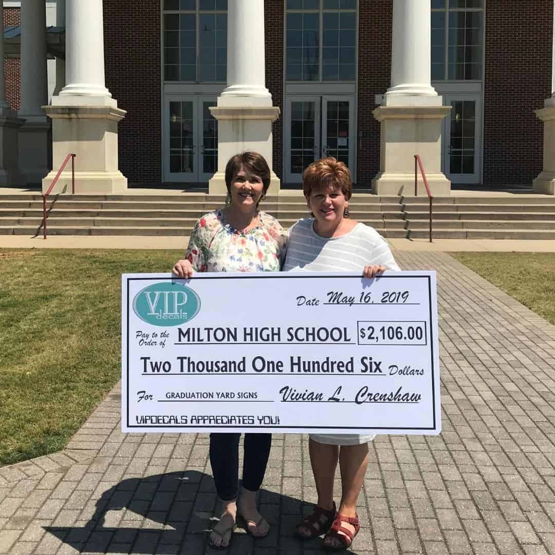 Milton parent holding 2019 high school graduation yard sign fundraiser check